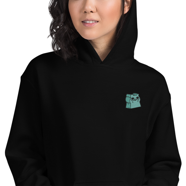 A model wearing a black hoodie with the Riverfolk Company otter meeple embroidered on the left chest.