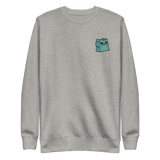 Light grey crewneck sweatshirt with the Riverfolk Otter meeple embroidered on the left chest. 