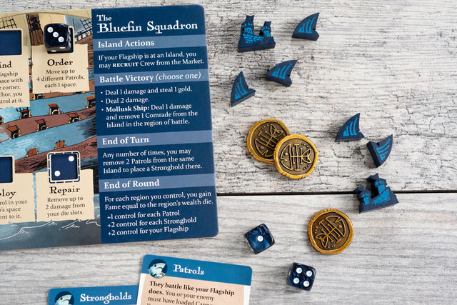 Photo detailing deluxe coins and screen-printed meeples for the Bluefin Squadron