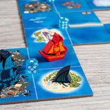 In-game photo showing the screen-printed ship meeples of the Bluefin Brigade and red Smuggler