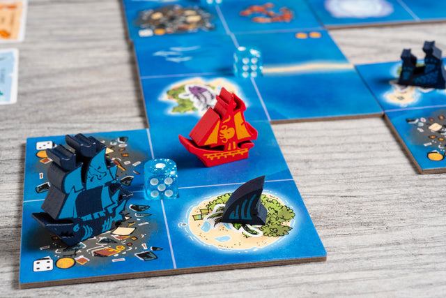 In-game photo showing the screen-printed ship meeples of the Bluefin Brigade and red Smuggler