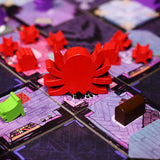 The red giant wooden spider meeple in play on the Mysterious Manor game board